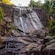 Waterfall cascading down a rocky cliff in Langkawi, Malaysia